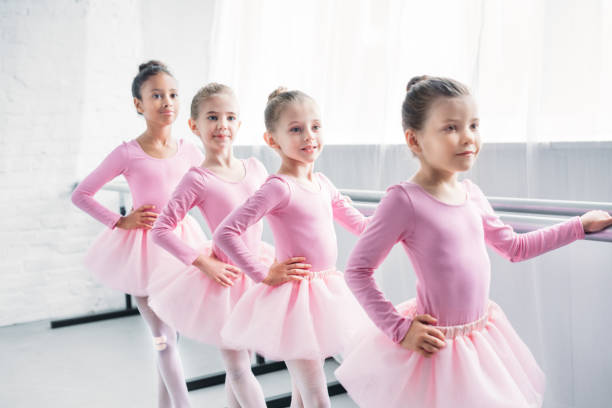 istock adorable little ballerinas practicing ballet in studio 1011838638
