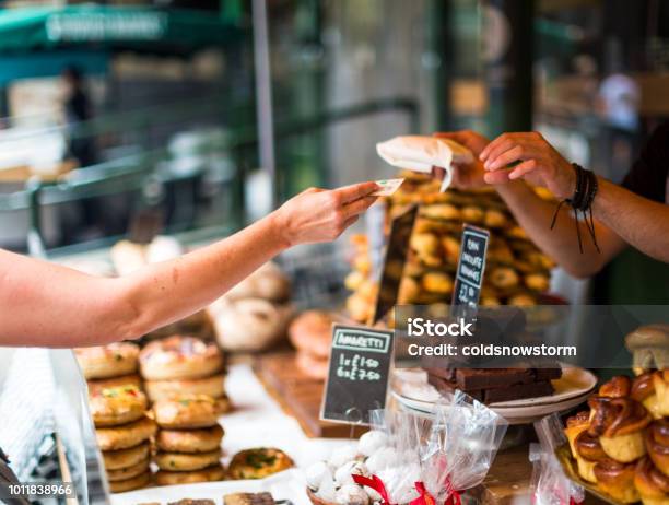 Customer Paying For Sweet Pastry Using Cash At Food Market Stock Photo - Download Image Now