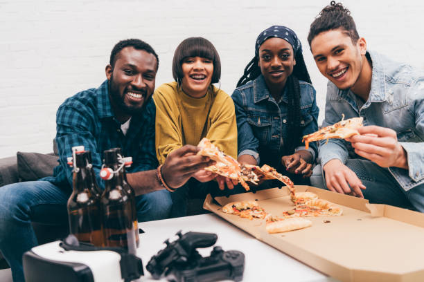 istock smiling group of young multicultural friends eating pizza 1011849746