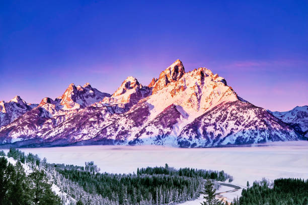 Sunrise in the Tetons A magnificent sunrise painting the Grand Teton colorful, taken at the snake river outlook in winter. wyoming stock pictures, royalty-free photos & images