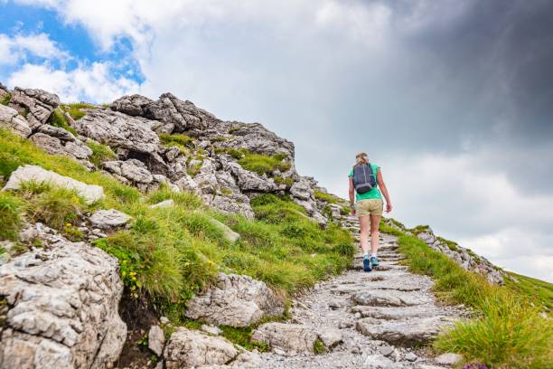 istock Woman walking on mountain trail 1011853228