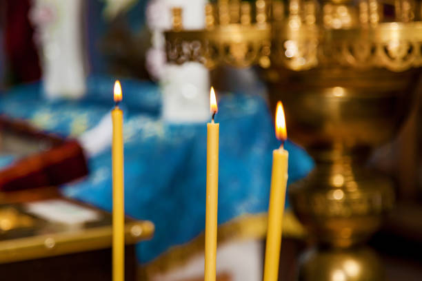 istock burning wax candles in the church 1011856090