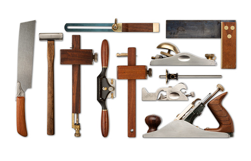 A selection of precision carpentry tools on a white backdrop, with drop shadows