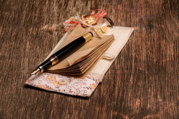 istock Designer notebook and ink pen on a wooden background 1011860756