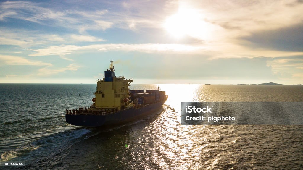 Cargo ship with sunset Beach Stock Photo