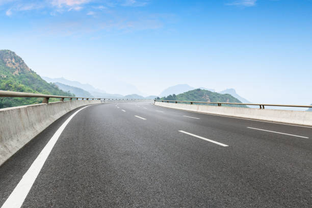istock Empty asphalt road and beautiful mountain scenery 1011864964