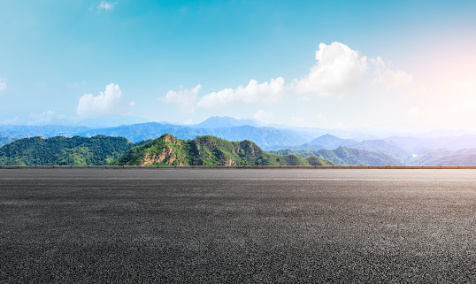 Asphalt road and beautiful mountain scenery under the blue sky