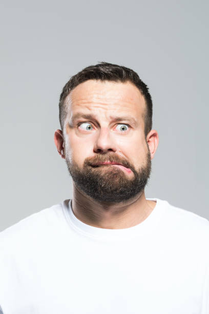 istock Headshot of shocked bearded young man, grey background 1011870870
