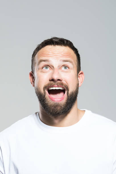 istock Headshot of surprised bearded young man, grey background 1011870928