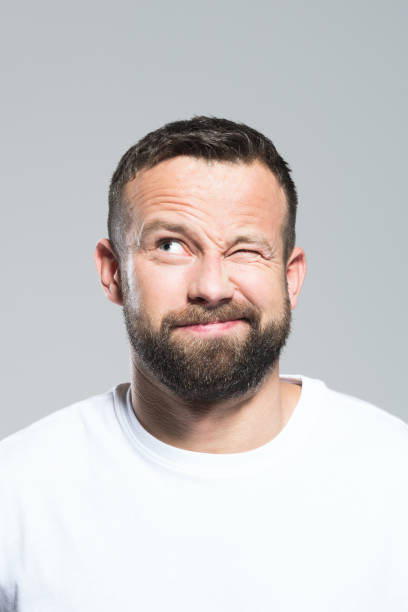 istock Headshot of surprised bearded young man, grey background 1011871008