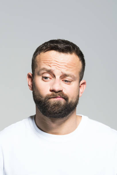 istock Headshot of worried bearded young man making a decision 1011871080