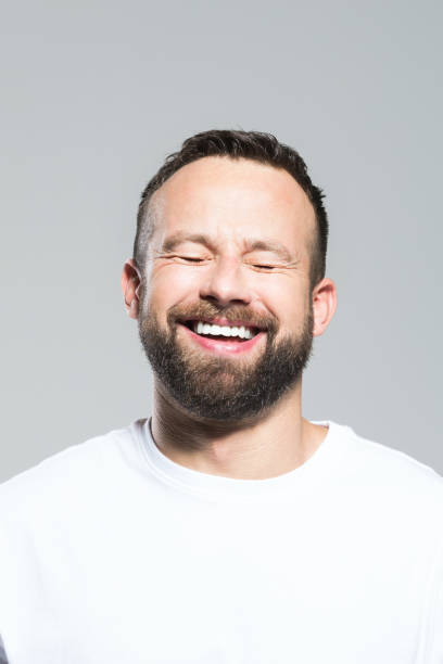 istock Headshot of happy bearded young man, grey background 1011871156