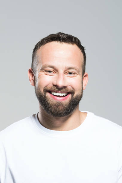 istock Headshot of excited bearded young man, grey background 1011871296