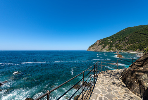 Coastline with cliffs and Mediterranean Sea near the small Village of Framura. La Spezia, Liguria, Italy, Europe