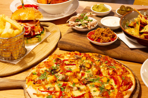 istock Pizza, nachos, pasta and burger on the table 1011880198