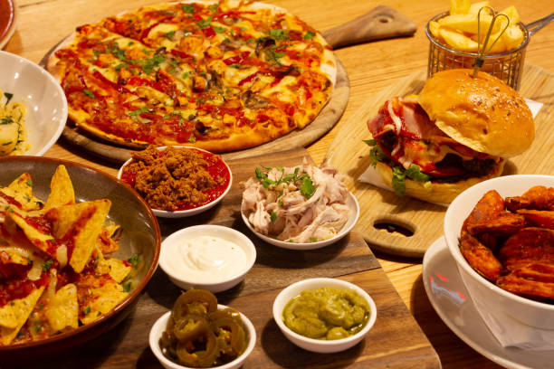 istock Pizza, nachos, pasta and burger on the table 1011880258