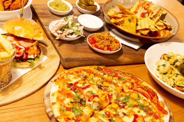 istock Pizza, nachos, pasta and burger on the table 1011880452
