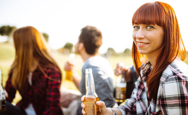 istock friends toasting beer at the park 1011880470