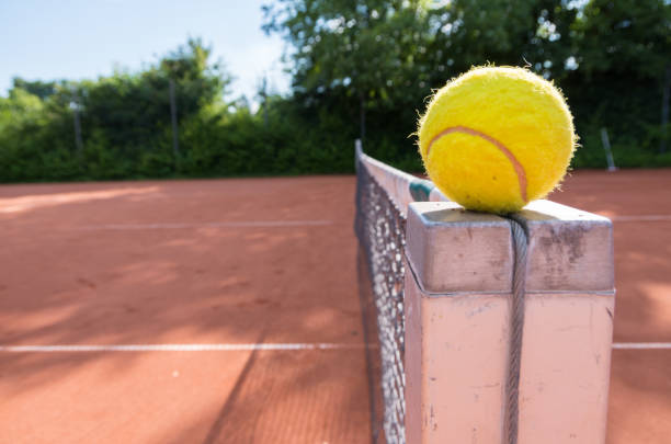 istock Tennis ball on net 1011892566