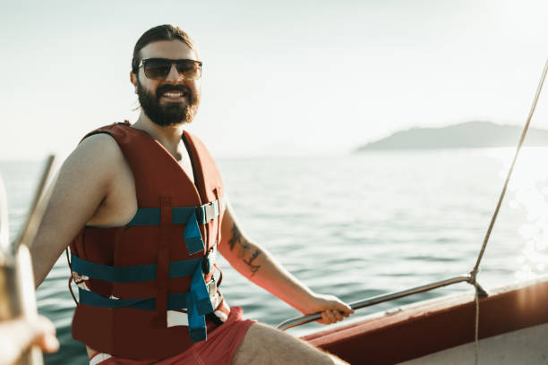 istock Handsome man having a boat ride and exploring an island in Greece 1011896944