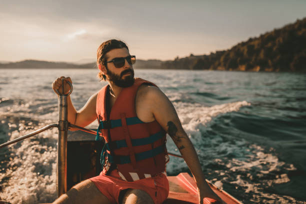 istock Handsome man having a boat ride and exploring an island in Greece 1011899140