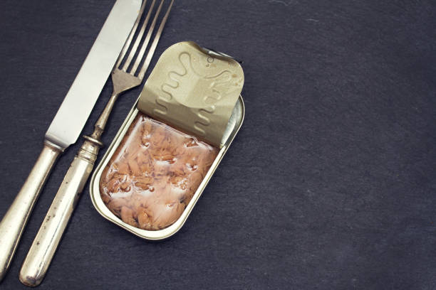 istock canned fish on wooden background 1011899340