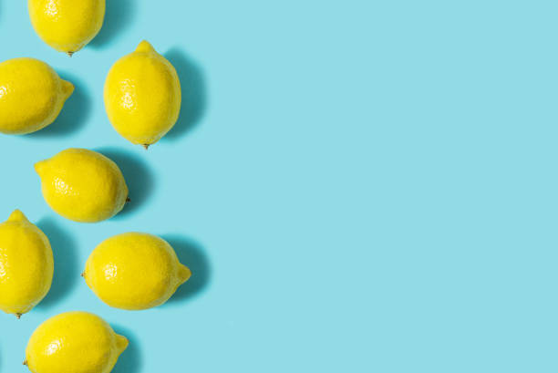 istock Top view of fresh lemon isolated on blue background. Fruit minimal concept. Flat lay. 1011899354