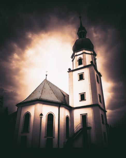 istock Eerie church in front of bright sky 1011899646