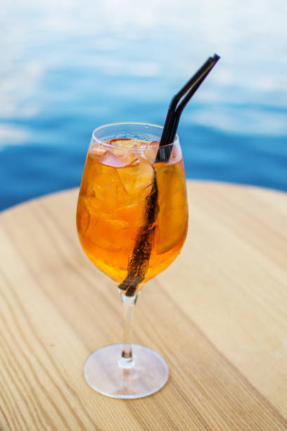istock Cold glass of Spritz appetizer stand on table near the river 1011900354