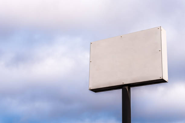 istock Day view of clear empty white banner on pole over cloudy sky 1011902526