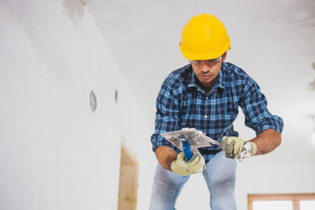 istock Young man finishing a drywall at home 1011905528