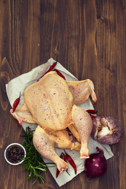 istock raw chicken with herbs and garlic on wooden background 1011905592
