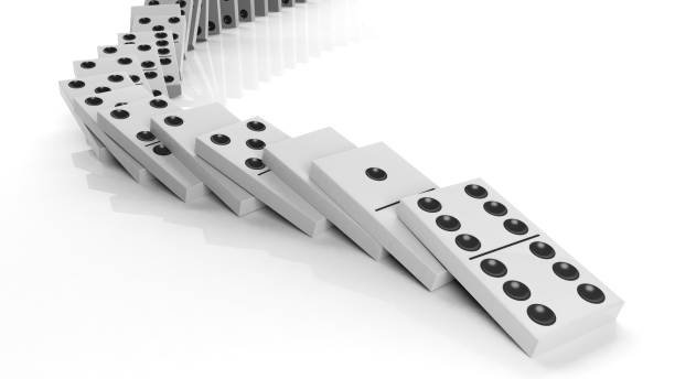 istock White domino tiles falling in a row, isolated on white 1011906304