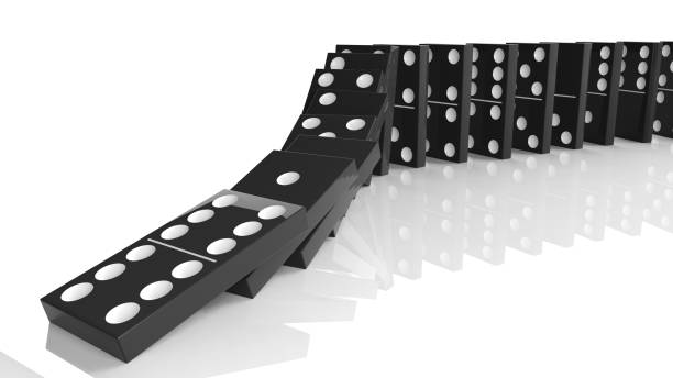 istock Black domino tiles falling in a row, isolated on white 1011906310