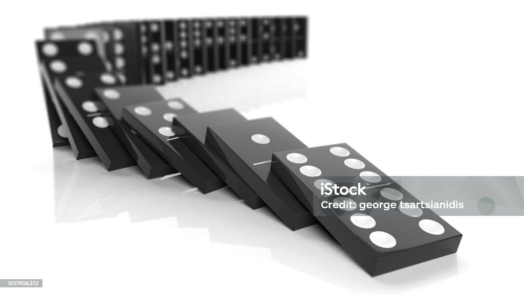 Black domino tiles falling in a row, isolated on white Domino Stock Photo