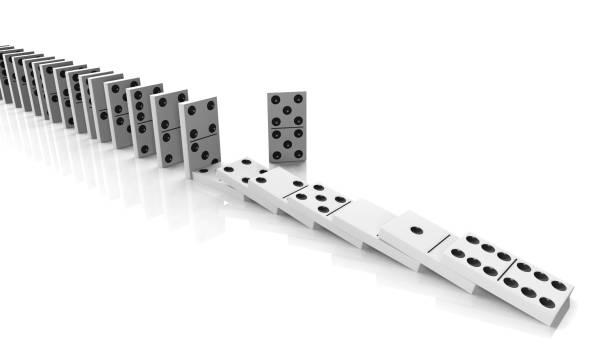 istock White domino tiles falling in a row with some standing, isolated on white 1011906316