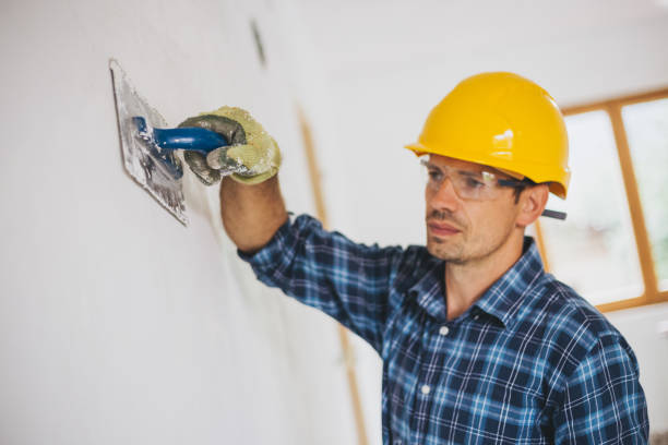 istock Young man finishing a drywall at home 1011910692