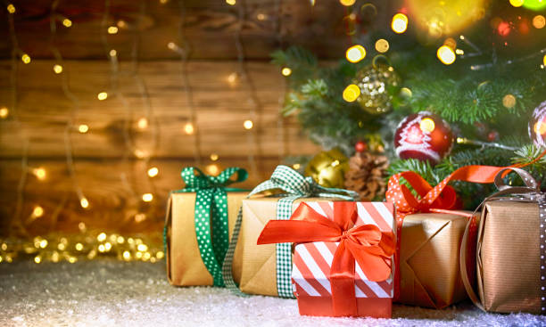 istock Christmas treewith gifts, rustic background 1011912188
