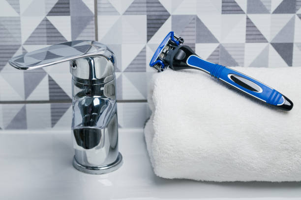 istock Blue razor in the toilet 1011914868