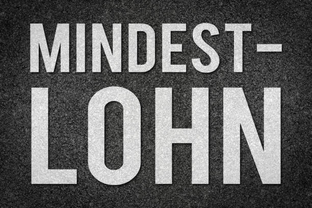 istock Minimum wage written in german on asphalt road as template 1011914928