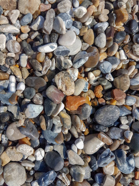 istock sea sand rocks pebbles beach top view background 1011915520
