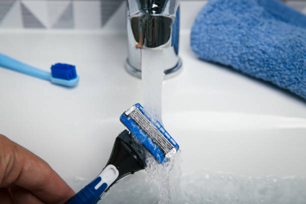 istock Blue razor in the toilet 1011915930