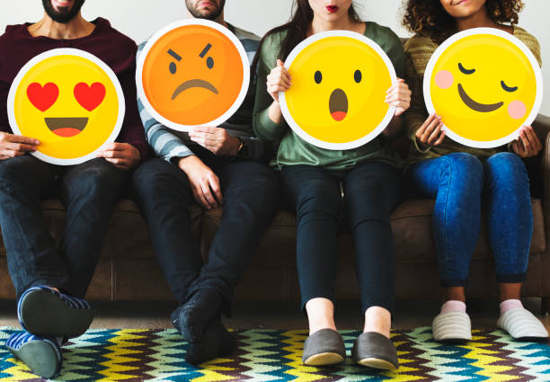 istock Group of diverse people holding emoticon icons 1011932890