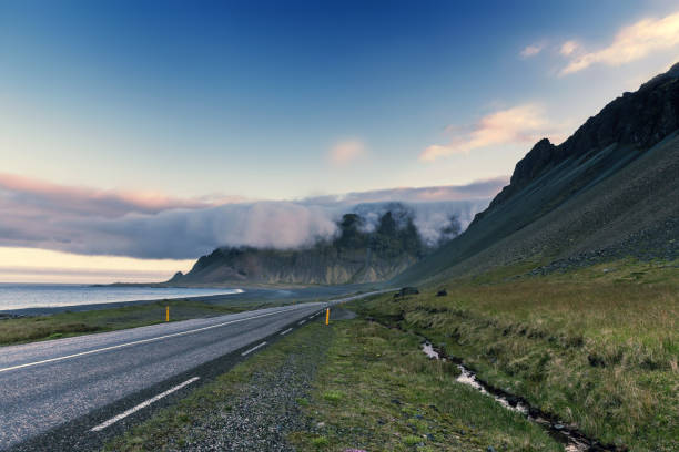 istock Mysterious mountains covered with clouds. On the road 1011935744