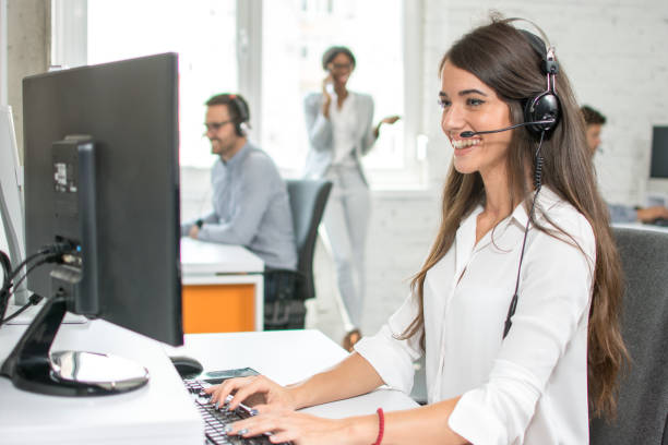 istock Happy smiling female customer service operator working on computer in office 1011935774