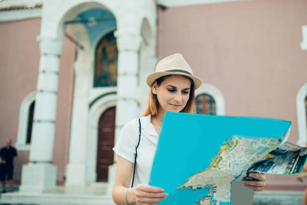 istock Young tourist with a map exploring Skiathos island on a summer day 1011935910