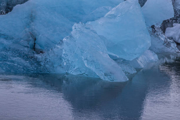 istock Iceberg parts floating on water 1011936066