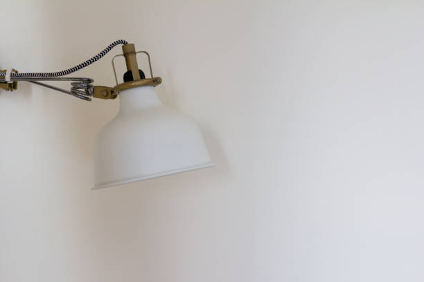 istock Asjustable white lamp on the wall background 1011950576