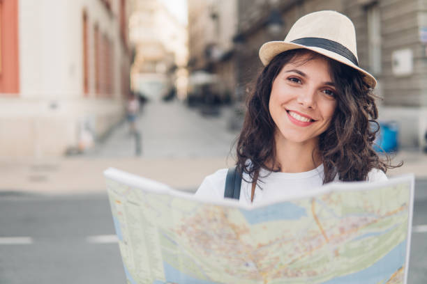 istock Smiling tourist with the map 1011951798