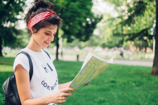 istock Young stylish girl reading the map 1011951804